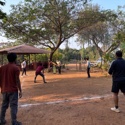 Participants are playing cricket at Mustardseed Campsite near mumbai,Outbound training campiste near mumbai